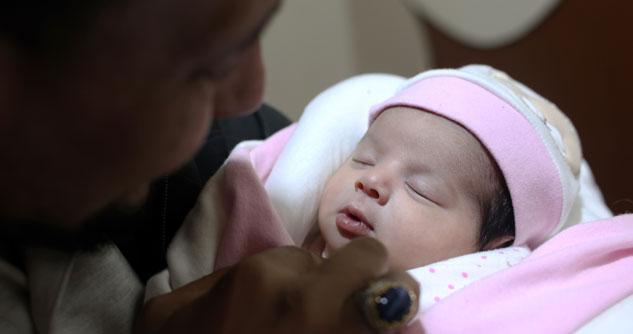 Man holding newborn in his arms